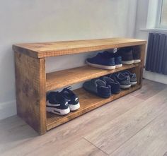 there is a wooden shelf with shoes on it