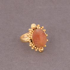 Wholesale Natural Sunstone Jewelry Supplier, Stylish Gold Plated Brass Ring, Orange Crystal Ring, Designer Fashion Ring Product Details Item Code: BJBR-2479 Stone Name: Sunstone Stone Shape : Oval Stone Size : 12*16mm Metal: 18K Yellow Gold Over Brass Ring Sizes: Please choose from drop down menu. If you do not see your finger size, select custom and I'll make a ring just for you!  Note :- This rings you will receive may vary slightly in color from the images because these are natural gemstones Orange Open Ring Jewelry For Gift, Sunstone Gemstone Jewelry For Jewelry Making, Sunstone Gemstone For Jewelry Making, Orange Moonstone Ring Gift, Orange Moonstone Ring As A Gift, Orange Open Ring Jewelry As Gift, Orange Moonstone Gemstone Ring, Amber Rings With Gemstone Accents For Gifts, Orange Carnelian Ring Jewelry