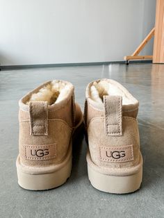 DESCRIPTION: The Classic Ultra Mini updates UGG's most iconic silhouette with a lower shaft height, adding easy on-off and enhanced versatility. Pre-treated to keep it looking better for longer, this classic features everything you love about the original signature UGG sheepskin and a flexible, lightweight sole. Wear with virtually anything – the styling options are endless. SIZE & FIT: True to size. If in-between, size down. 3.5" shaft height MATERIAL & CARE: Sheepskin/lyocell insole Uggs Ultra Mini Sand, Ugg Ultra Mini Sand, Ugh Mini Boots Outfit, Cute Fall Shoes, Uggs Ultra Mini, Ugg Sand, Ultra Mini Uggs, Cute Uggs, Ugg Ultra Mini