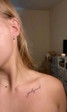 a woman with a small tattoo on her chest