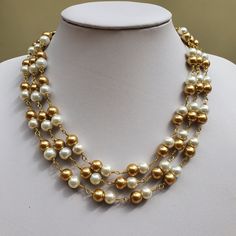 This beautiful white and golden pearl multistrand necklace and earring set is perfect for bridesmaids jewellery! or Valentine gift! Necklace : I have made it with 8 mm white and golden glass pearl beads. 2 pearls are looped together to form the beaded chain. There are 3 such beaded chains arranged in layers where they fall close to each other.Finished with beautiful antique gold finish chandelier connectors and lobster claw clasp. Length of the necklace is 17 inches with shortest strand and 19 i Gold Double Strand Pearl Necklaces, Multi-strand Gold Pearl Chain Jewelry, Gold Multi-strand Pearl Chain Jewelry, Gold Multi-strand Pearl Necklace, Gold Layered Necklace With Pearl Drop For Gift, Gold Pearl Multi-strand Layered Necklace, Gold Multi-strand Pearl Layered Necklace, Gold Double Strand Pearl Necklace, Pearl Drop Multi-strand Jewelry Gift