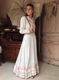 "Beautiful antique cotton day dress from the 1880s.This dress has a lovely lilac floral print and tiny pure silk ribbons in beautiful colors.  There is some fading in the pattern, and the silk ribbons have a discoloration too. But the silk is still in amazing condition! The skirt has a ruffled bottom line. This gives the skirt some heavy lower part. Which makes the skirt flow so wonderful while walking. And look at the lovey floral print! The bodice has a cotton lining and is wearable with bust Prairie Dress 1912, Victorian Dress For Garden Party, Victorian Cotton Prairie Dress For Spring, Spring Victorian Dress For Garden Party, 1900s Womens Fashion, 1880s Dress, 1890s Dress, 1880 Dress, 1880 Fashion