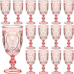 a set of twelve pink glass goblets sitting next to each other on a white background