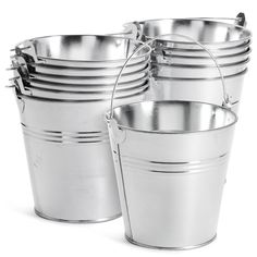 several metal buckets stacked on top of each other