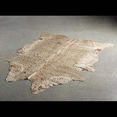 a cowhide rug is laying on the floor