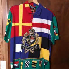 Polo Crest Shirt In Excellent Condition. Worn Only Once Designer Short Sleeve Multicolor Shirt, Designer Multicolor Graphic Print Tops, Multicolor Polo Collar Top With Graphic Print, Multicolor Graphic Print Polo Collar Top, Multicolor Graphic Print Top With Polo Collar, Multicolor Graphic Print Short Sleeve Polo Shirt, Designer Multicolor Collared Tops, Ralph Lauren Polo, Ralph Lauren Shirt