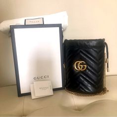 Gucci Black Bucket Bag Bag Is In Excellent Pre Owned Condition. Gucci Bag Comes With Removable Key Ring, Cards Of Authenticity, Dust Bag, And Box. Gucci Bag Features Soft Calfskin Leather, Beautiful Stitched Chevron Pattern, Aged Chain Shoulder Strap, Top Cinch Sides, And Aged Gold Gg Logo. Back Of Bag Has A Stitched Heart. Interior Of Bag Opens To Beige Microfiber, Cards Slots, And Removable Key Ring. Detailed In Pictures Is A Minor Blemish. Looks Like A Smudge/Crease And May Be Removable. Otherwise This Gucci Bag Is Clean And Imperfection Free. Very Minor Wear. Was Stored In Bag And Box In My Home. Thanks For Checking Out! Black Bucket Bag, Black Bucket, Gg Logo, Gg Marmont, Strap Top, Gucci Black, Bag Bag, Chevron Pattern, Key Ring