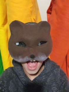 a boy wearing a cat mask with his mouth open