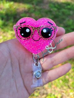 Glittered Heart with Leopard Glasses Acrylic Retractable Badge Reel! Great gift for nurses, doctors, teachers or anyone that wears a ID Badge! Perfect for Valentine's day! Available permanently attached to a stationary alligator, a 360o swivel alligator, or a slide-on clip. This hearts badge reel is made with an acrylic blank, glitter, vinyl, and resin. The Glitter is sealed in and will not come off. Measures approximately 2 inches on longest side Badge reels are made to order so please check estimated turnaround time BEFORE ordering. Contact me before ordering if you need by a certain date, and I will let you know if this can be accommodated. Please handle with care! They are sturdy, but may break if dropped or knocked against a hard surface just right. Wipe clean with a soft cloth or a w Cute Pink Badge Holders For Gift, Cute Pink Badge Holders As Gift, Cute Pink Badge Holder As Gift, Pink Novelty Craft Supplies For Gifts, Fun Pink Craft Supplies For Gifts, Cute Pink Badge Reel For Birthday, Novelty Pink Craft Supplies For Birthday, Pink Novelty Craft Supplies For Birthday, Pink Plastic Craft Supplies For Gifts