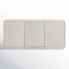 a white cabinet sitting on top of a wall