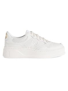 Find GUCCI Gg Embossed Leather Sneakers on Editorialist. Leather upper Round toe Lace-up vamp GG embossed logo Rubber sole Made in Italy Please note: This style runs a half size small. This brand fits slightly smaller. Consider ordering half a size up. ABOUT THE BRAND First launched in 1921, the Italian luxury fashion house quickly became known for its fine leather craftsmanship and accessories. Today, the visionary brand continues to redefine fashion trends, while celebrating creativity and inn Tenis Gucci, Lipstick Bag, Gucci Sneakers, Chain Strap Bag, Oversized Tote Bag, Floral Shoes, Latest Sneakers, Trending Sneakers, Suit Accessories