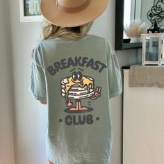 Get ready to be OBSESSED with your new Breakfast Club pancake shirt. It's the cutest and most trendy way to emit all those retro brunch vibes! Crafted from the softest fabric, this Comfort Colors tee ensures the utmost comfort throughout the day. * Q U I C K F A C T S * ✺ 100% preshrunk cotton ✺ Wash and dry on delicate, inside out (on cool for best results) * S I Z I N G * ✺ Models are wearing size Large ✺ Sizing is unisex so runs like men's, though not overly large ✺ Most women find their typi Cotton T-shirt With Letter Print For Brunch, Relaxed Fit Cotton Shirt For Brunch, Cotton Shirt With Relaxed Fit For Brunch, Funny Print Graphic Tee For Brunch, Funny Print Short Sleeve T-shirt For Brunch, Casual Screen Print T-shirt For Brunch, Cute Oversized T-shirt With Funny Print, Short Sleeve Tops With Funny Print For Brunch, Short Sleeve Screen Print Tops For Brunch