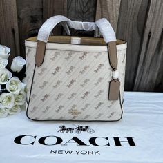 Printed Coated Canvas And Smooth Leather Inside Zip Pocket Snap Closure Handles With 9 1/2" Drop 10 3/4" (L) X 9" (H) X 4 1/2" (W) Style No. C4060 Coach Market Tote, Coach Fragrance, Banana Print, Horse And Carriage, Coach Tote Bags, Coach New York, Coach Tote, Bags Coach, Coach Leather