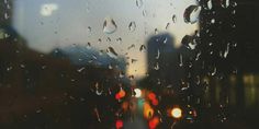 rain drops on the window with buildings in the background