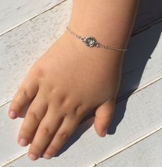 a child's hand with a bracelet on it