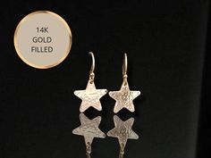 Check out this item in my Etsy shop https://www.etsy.com/au/listing/1275828405/hammered-gold-star-earrings-small-gold Gold Star Earrings