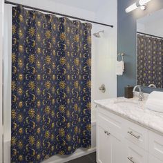 a bathroom with blue and yellow shower curtain next to a white counter top under a mirror