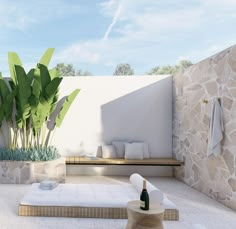 an outdoor bathroom with stone walls and white tile flooring is featured on instagram