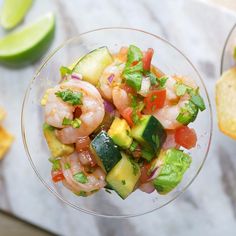 shrimp and avocado salad in a glass bowl with tortilla chips on the side