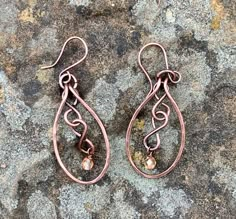 Hammered Copper with copper figure eights and flame colored crystal dangles. Come on handmade copper ear wires.Approximately 2" long from the top of the ear wire and 13/16" wideThese Earrings have been antiqued, polished and sealed.Sealed with Protectaclear ProtectaClear is a clear, protective coating that is tough enough to protect jewelry and is safe for wear against skin. ProtectaClear is practically invisible once applied and will seal and protect jewelry from tarnish, oxidation, and corrosi Jewelry Techniques Earrings, Colored Wire Jewelry, Wire Wrapped Copper Teardrop Dangle Earrings, Bronze Teardrop Copper Earrings, Artisan Copper Teardrop Earrings, Bronze Copper Teardrop Earrings, Artisan Teardrop Copper Earrings, Hand Forged Copper Wire Drop Earrings, Bronze Wire Wrapped Copper Earrings