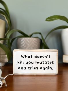 a wooden sign that says, what doesn't kill you mutates and tries again