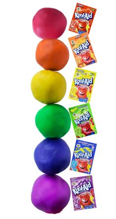 four balls stacked on top of each other with candy bars in the bottom and two gummy