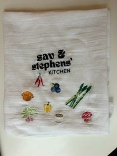 a kitchen towel with embroidered vegetables on it and saying say & stephen's kitchen