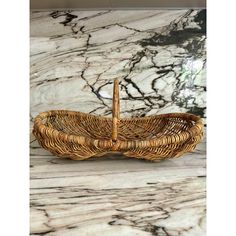 a wicker basket sitting on top of a marble counter