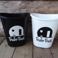 two black and white plastic cups with trailer trash written on the side, one has an i love trailer trash