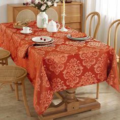 an orange table cloth on a dining room table