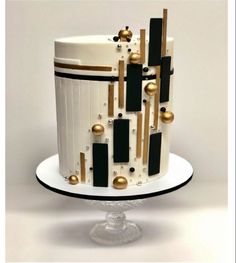 a white and black cake with gold decorations