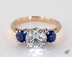 a three stone diamond and blue sapphire ring