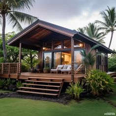 a small wooden house sitting on top of a lush green field next to palm trees