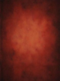 an orange and red background with some black spots