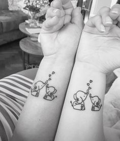 two people with matching tattoos on their arms