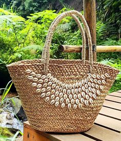 This beautiful handwoven basket bag is made of natural seagrass with cowrie shells stitch on it, the perfect accessory for the summer as a picnic basket bag, bride beach bag with a natural color this bag is easy to mix and match with any outfit. ● Material: Seagrass, cowrie shells ●Quantity listed: 1pc ●Dimension:  Length: 55 cm (top) - 21 inches  Height:  28 cm - 11 inches  Bottom: 20x23 cm - 7x9 inches  ♥ USAGE ● Beach Bag to carry some beach stuff's ● Handbag for just strolling in the city ● Summer bag ●PACKING: We'll be wrapped in white paper, bubble wrap, black stretch film plastic. SHIPPING INFO ● Processing time: 1-2 working days ● Shipping it will take between 2-7 business day by Express DHL or FedEx depending on your location   Asia Pacific: 2-4 days   Australia and New Zealand 3- French Basket, Custom Beach Bags, Beach Basket, City Summer, French Baskets, Stretch Film, Birthday Presents For Her, Seagrass Basket, Bag Packing