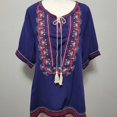 Effortless And Chic, The Perfect Pairing For Your Favorite Jeans Or Leggings. Blue With Red Embroidery Tassel Tie Tunic. Size Large 20" Bust 29" Length 100% Cotton Dry Clean Blue Spring Tops With Tassel Ties, Blue Spring Top With Tassel Ties, Blue Tassel Tops For Summer, Blue Beach Tops With Tassels, Blue V-neck Tops With Tassels, Blue V-neck Top With Tassels, Beach Blue Tops With Tassels, Blue Tassel Tops For Beach, Bohemian Blue Top With Tassels