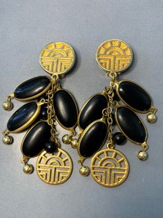 CLASSIC LOUIS FERAUD Bijoux Vintage 1980s Gold Tone Black Matte Resin Iconic Logo Statement Paris French Rare Signed Dangly Clip On Earrings. Just a FABULOUS Pair of Large long Dangly Clip On earrings with the logo at the top and Bottom, Oval pieces of resin set in a gold mount, Classic and fantastic stylish, superb quality, signed at the back, Black and gold..a great colour combination for many outfits! measurements: 9.5cm by 3cm Condition: In ABOVE excellent vintage condition, The clips are se Black Vintage Clip-on Earrings, Black Retro Earrings, Vintage Black Metal Earrings, Black Vintage Metal Earrings, Vintage Black Metal Clip-on Earrings, Black Retro Clip-on Jewelry, Louis Feraud, Antique Jewellery, Vintage Costumes