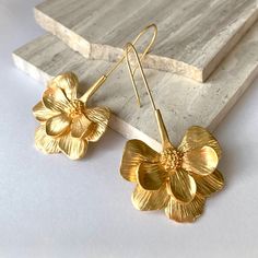 New~ Anthropologie Long Gold Flower Earrings These Elongated Flowers, In A Matte Gold Finish, Will Brighten Up Your Day. Add These To Any Outfit For A Bright & Fresh New Look! Approx: 2.5"L, 1.5"W. Nwot, Gold Plated. Anthro, Anthropologie, Shiny Gold, Flowers, Flower, Bold, Statement Earrings, Natural, Earthy, Trendy, Boho, Bohemian, Everyday Jewelry Flower Wire Earrings, Adjustable Gold Jewelry With Handmade Flowers, Brass Flower Charm Earrings, Elegant Flower Shaped Brass Earrings, Gold Flower Earrings With Handmade Details, Handmade Flower Gold Jewelry For Gifts, Handmade Flower Shaped Gold Jewelry, Handmade Flower Gold Jewelry Gift, Gold Jewelry With Handmade Flowers