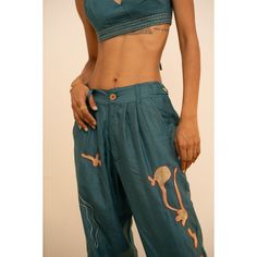 Our favorite silk trousers features hand-embroidered designs inspired by the ocean, its corals, and marine life by Lambani artisans, while the Eri (peace) Silk composition provides a soft and luxurious feel. The vivid ocean blue hue (created from a combination of marigold and indigo natural dyes) adds a perfect touch of vibrancy. Whether paired with the Coral Bralette and the Coral Silk Shirt or worn on its own with another top in your closet, this is a stylish statement piece is an artful and t Traditional Silk Pants For Summer, Bohemian Silk Wide-leg Pants, Bohemian Silk Wide Leg Pants, Bohemian Wide Leg Silk Pants, Festive Wide Leg Silk Pants, Festive Wide Leg Silk Bottoms, Blue Bohemian Embroidered Pants, Bohemian Blue Embroidered Pants, Traditional Silk Straight Pants