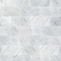 a white marble tile wall that looks like it is made out of tiles