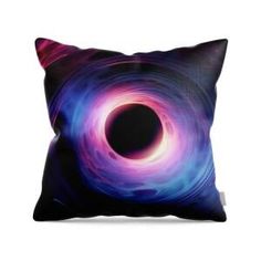 a pillow with a black hole in the center and purple, blue, and red swirls on it