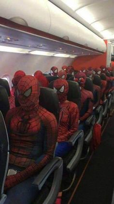 there are many spider man sitting on the airplane