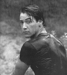 a black and white photo of a man in wet clothes