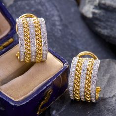 These dazzling clip-on Toni Cavelti designed earrings are each accented with three-rows of twelve (12) round brilliant cut diamonds bead set into platinum. The diamonds rows alternated with 18K yellow gold rope motifs. The earrings measure 16.3mm X 10.4mm and are finished with omega hinged backs. Signed CAVELTI 18K PLAT. Classic Clip-on Diamond Earrings, White Gold Clip-on Earrings With Diamond Accents, White Gold Diamond Clip-on Earrings With Diamond Accents, Luxury Yellow Gold Clip-on Diamond Earrings, Luxury Clip-on Earrings With Cubic Zirconia, Luxury Brilliant Cut Clip-on Earrings For Anniversary, Classic Yellow Gold Diamond Clip-on Earrings, Anniversary Diamond Clip-on Earrings, Fine Jewelry Diamond Clip-on Earrings With Accents