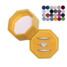 an open yellow velvet ring box with three diamond rings in it and the lid opened