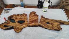 three pieces of wood sitting on top of a white table covered in waxe paper