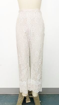 Mod 1960s handmade lace pant set - Skinny strap white lace tunic with sweetheart neckline and scalloped hem. Metal zipper on the back with hook-and-eye closure at top. Fully lined with blush fabric and nude overlay. - Cropped straight leg high-rise white lace pants with scalloped hem. Side metal zipper and hook-and-eye closure on tab. Fully lined in blush fabric with nude overlay. Label: Fashioned by Ruth Steele Feminine Wedding Bottoms With Lace Trim, Feminine Lace Trim Bottoms For Wedding, Fitted White Pants With Lace Trim, White Delicate Lace Bottoms For Party, Elegant White Bottoms With Lace Patchwork, Fitted White Lace Pants, Chic Lace Bottoms For Wedding, Wedding Lace Bottoms, White Lace Bottoms For Weddings