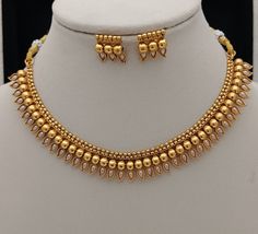 Gift yourself a royal look with this perfect necklace set from ISMI CREATIONS. Crafted with high quality gold platings, it is impressive in design. Perfect for weddings and festivities, this gold necklace set should be put on with your favorite sari, lehenga or any party wear dress Raw material - artificial jewelry, CZ Diamonds Necklace Necklace Length  = 16 CM  Earrings Length   =  2 CM 100% Satisfaction Guarantee: 1 Year Warranty, Long Lasting Plating, High-Quality Stones. Occasion: Perfect ch Emerald Necklace Indian Gold Jewellery, Gold Necklace Set Long, Marathi Necklace, Gold Necklace Set Bridal, Simple Necklace Designs, Sari Lehenga, Red Stone Necklace, 22k Gold Necklace, Neck Pieces Jewelry