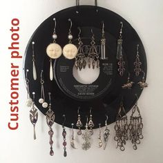 a record with earrings hanging from it's side